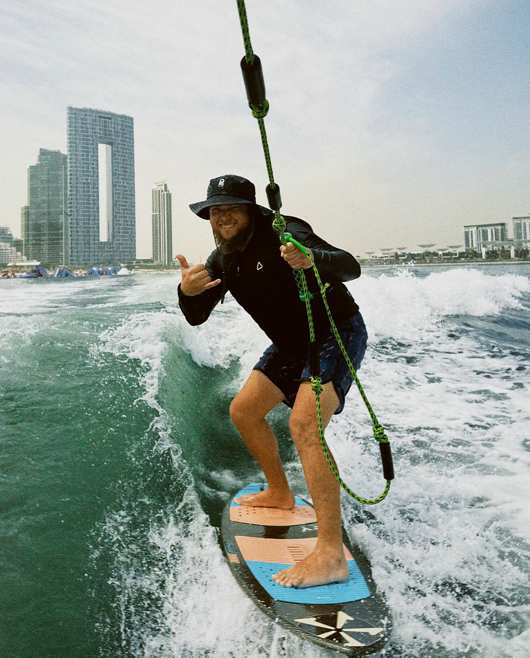 Rider on the rope with Dubai towers behind
