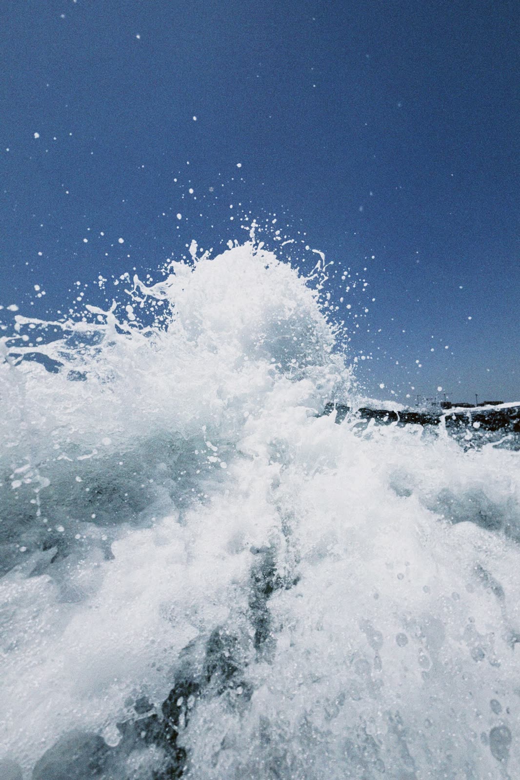 Wake spray in blue water