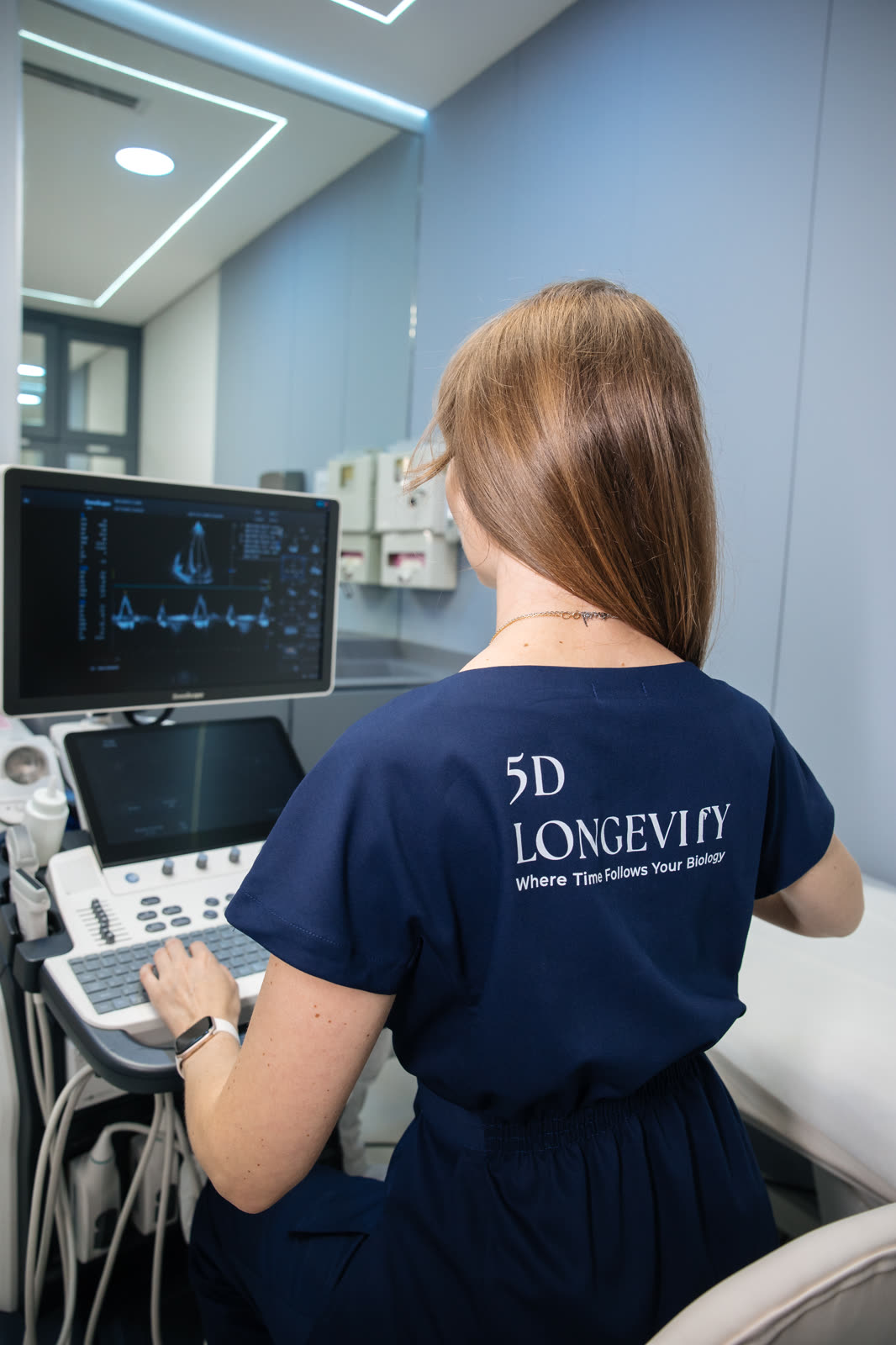 Specialist at a diagnostic screen, 5D Longevity uniform